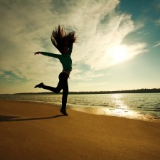 Power of Determination: Woman Jumping On The Beach On Sunny Sky Background, Freedom And