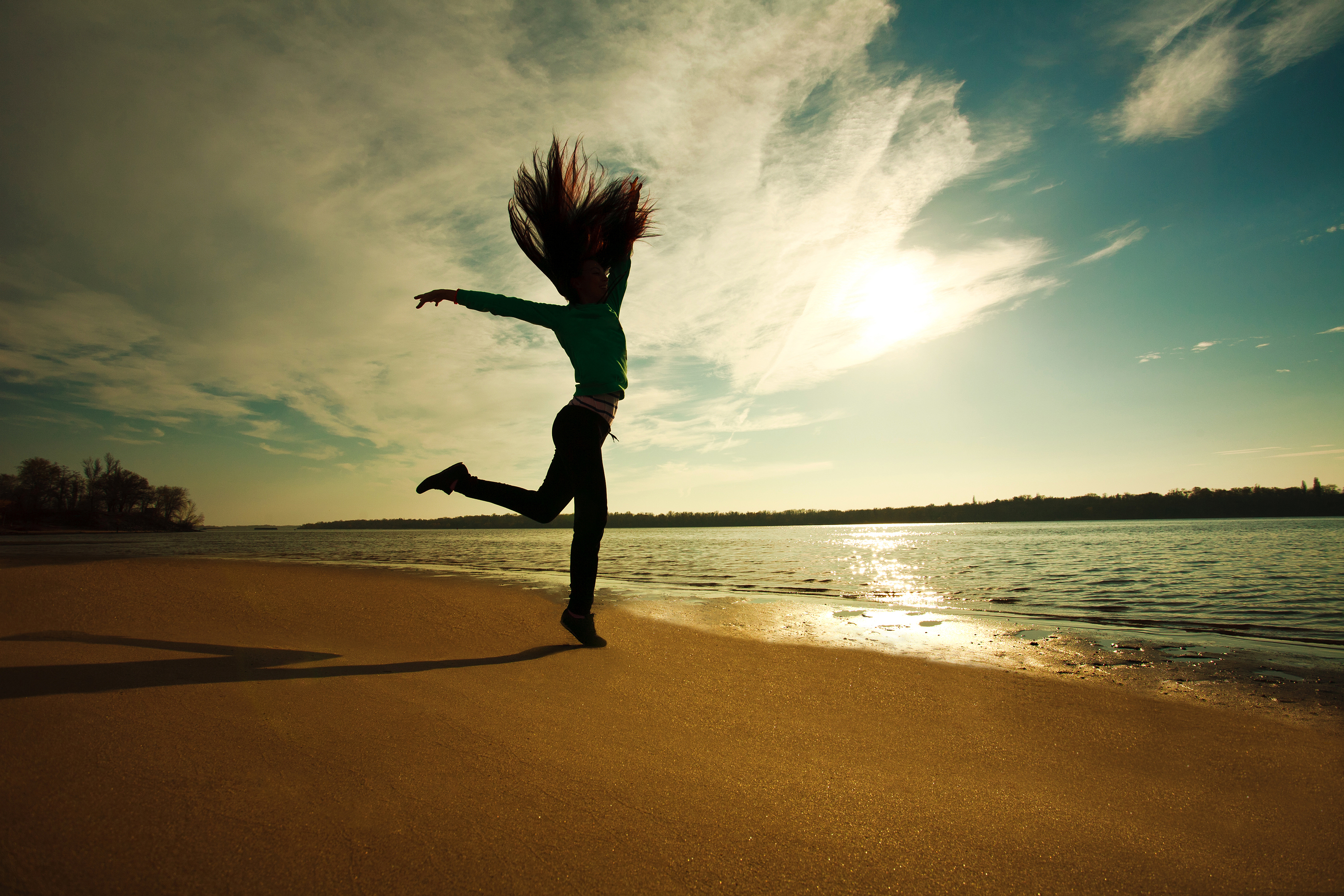 Power of Determination: Woman Jumping On The Beach On Sunny Sky Background, Freedom And