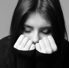 Black and white closeup portrait of a nervous woman