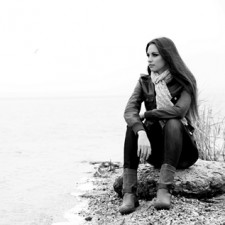 Manage Stress: Portrait of young serious woman near river