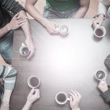 Creative Setting: Students sitting around table drinking coffee in college cafe